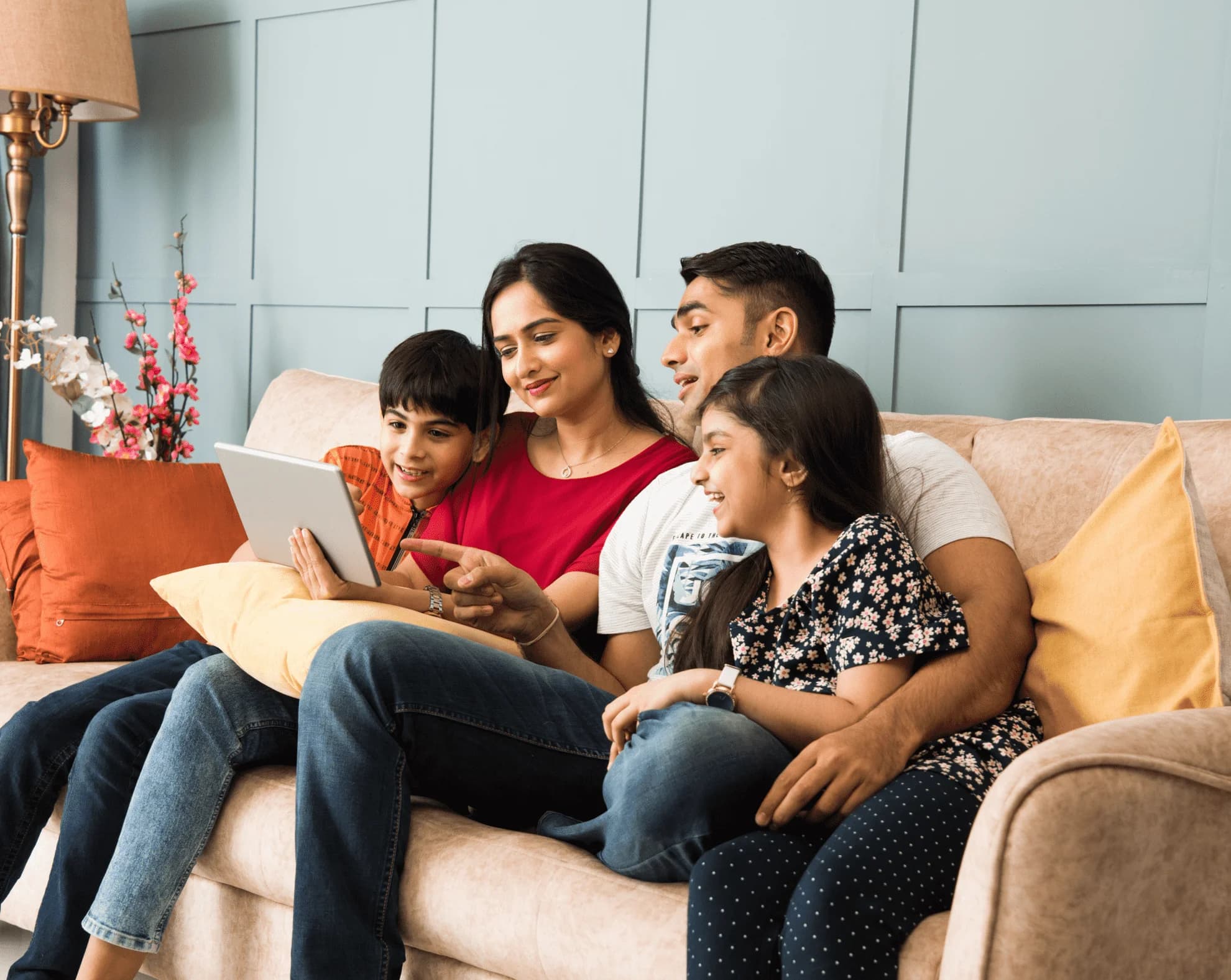 Family using tablet on couch